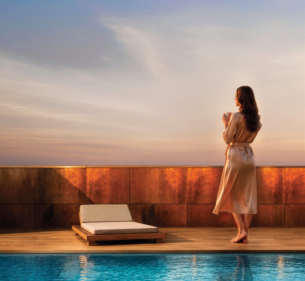 Resident by the rooftop pool at sunset
